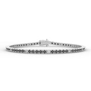 a white gold bracelet with black and white diamonds